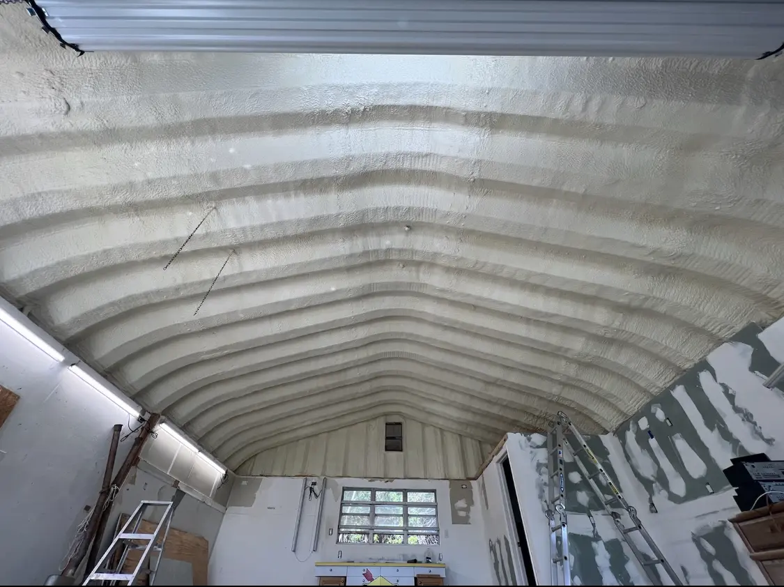 Spray polyurethane foam applied to the underside of a metal roof deck in Brownville